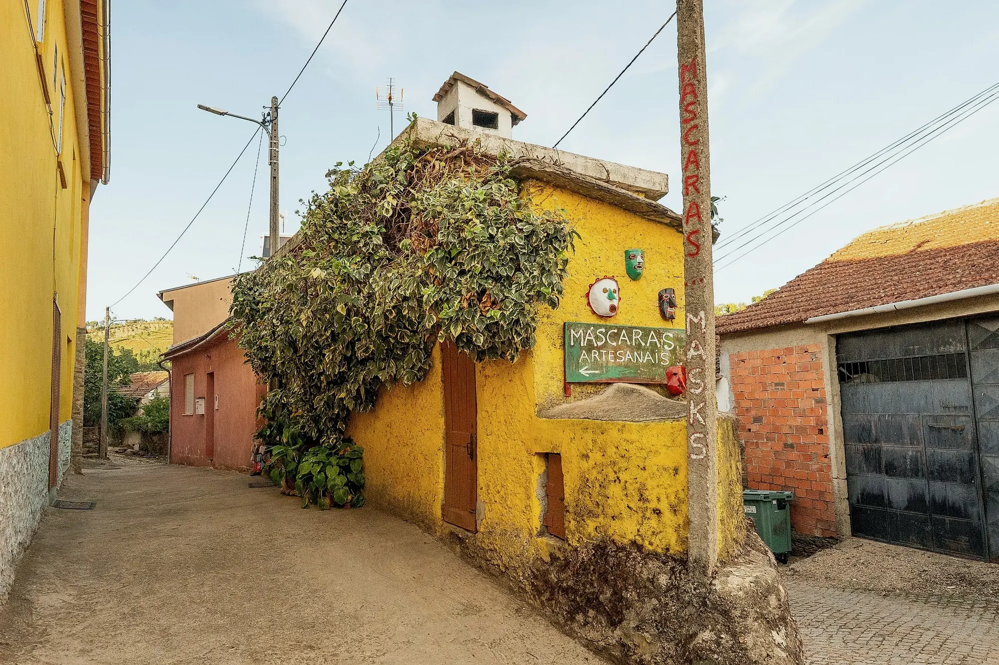 Casa amarela com a oficina de máscaras artesanais, em Aveleda